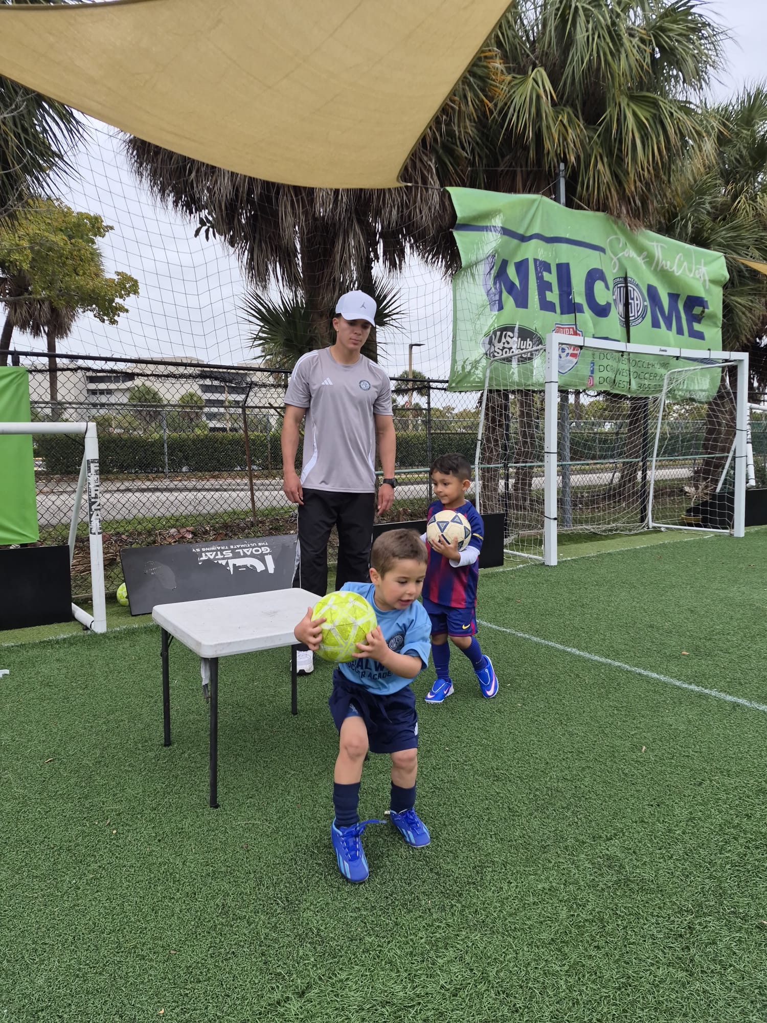Young recreational soccer players training with a coach